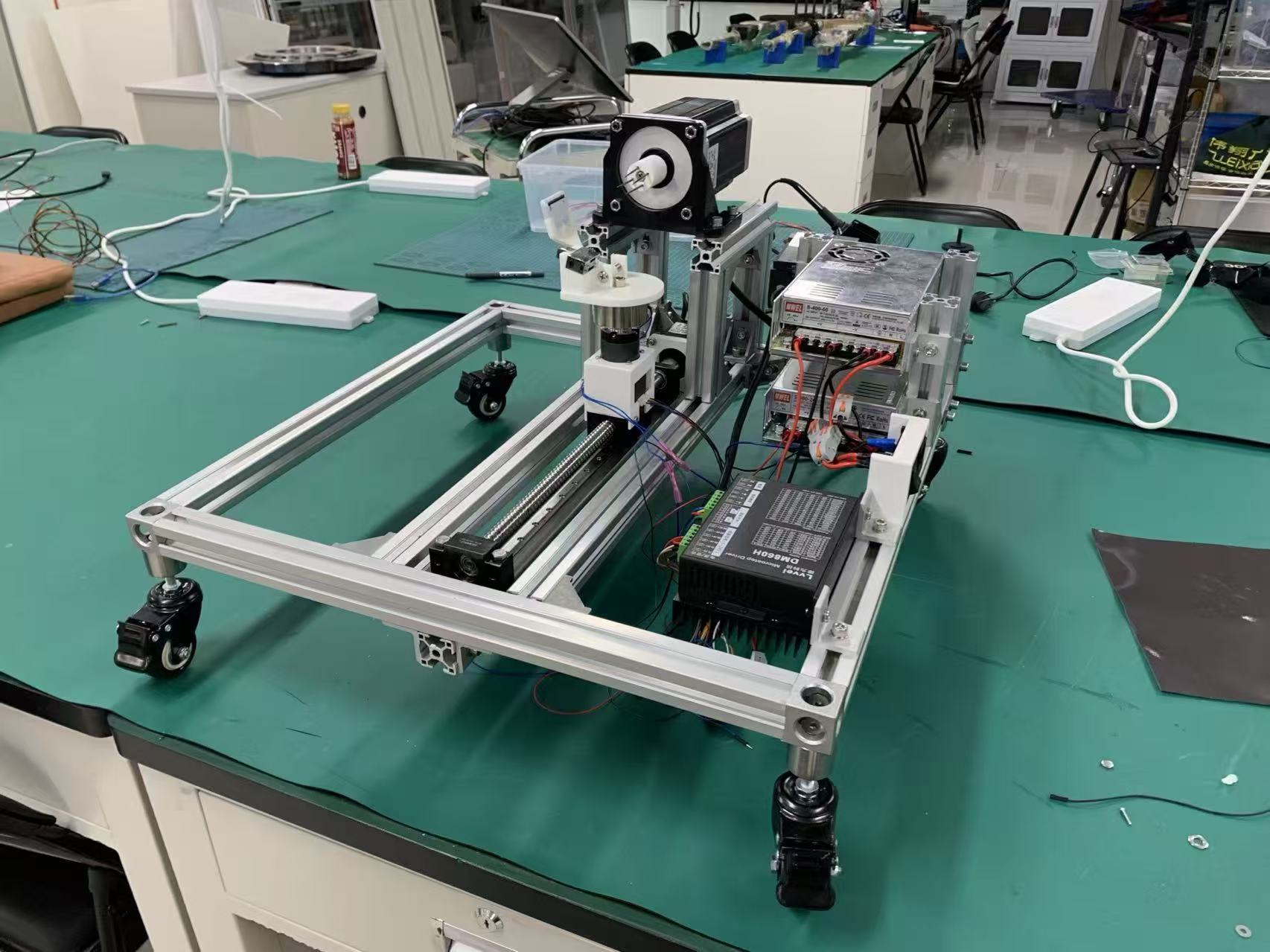 Current physical peeling prototype with its vertical axis, spindle, control hardware, and aluminum frame