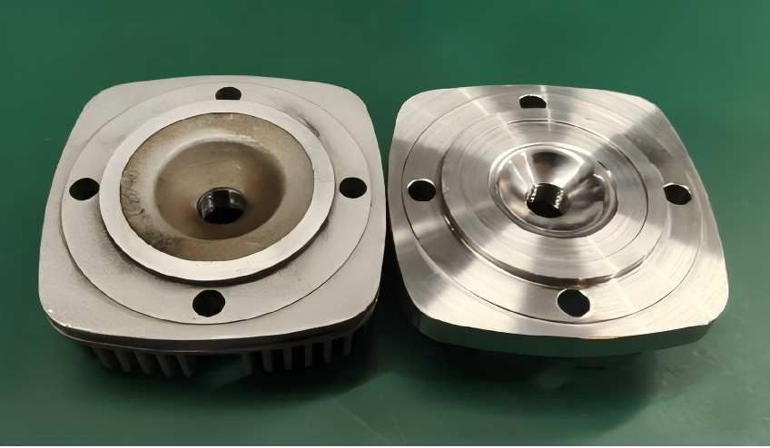 Photograph of the stock GTT70 cylinder head beside the redesigned high-compression cylinder head
