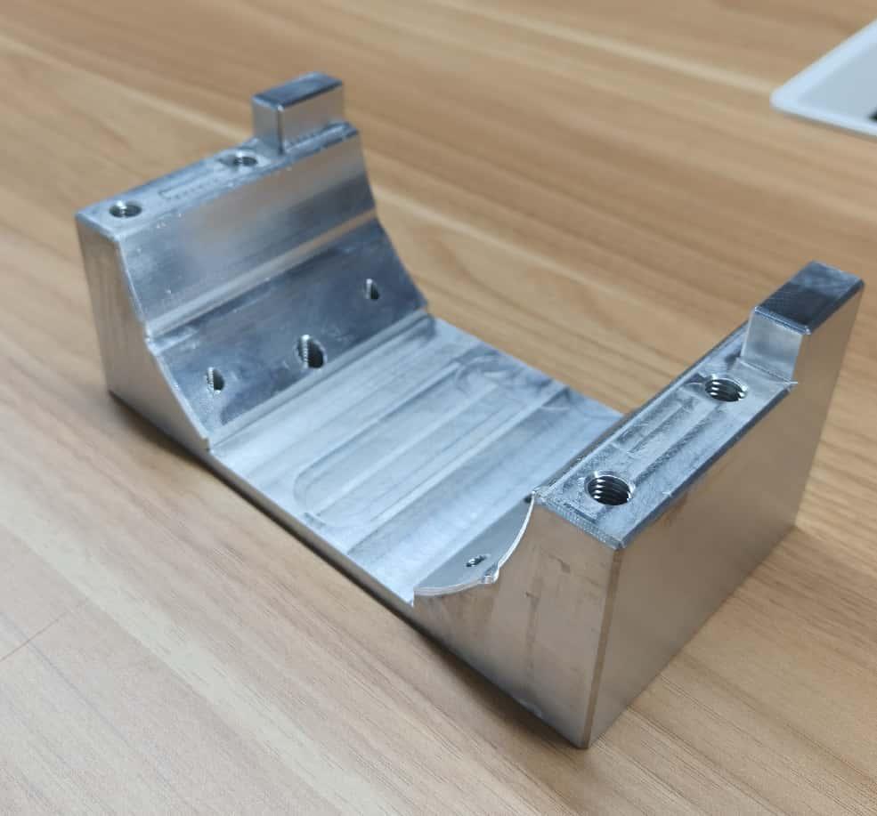 Manufactured aluminum motor mount on a workbench